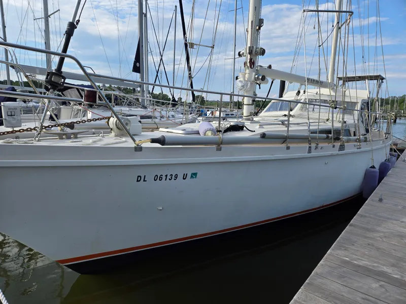 Slide: The Image of 1985 Amel Maramu sailboat docked at a marina, showcasing its sleek design and sturdy build. - 40