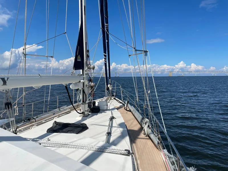 Slide: The Image of Sailing on 1985 Amel Maramu yacht under clear blue skies and calm sea. - 42