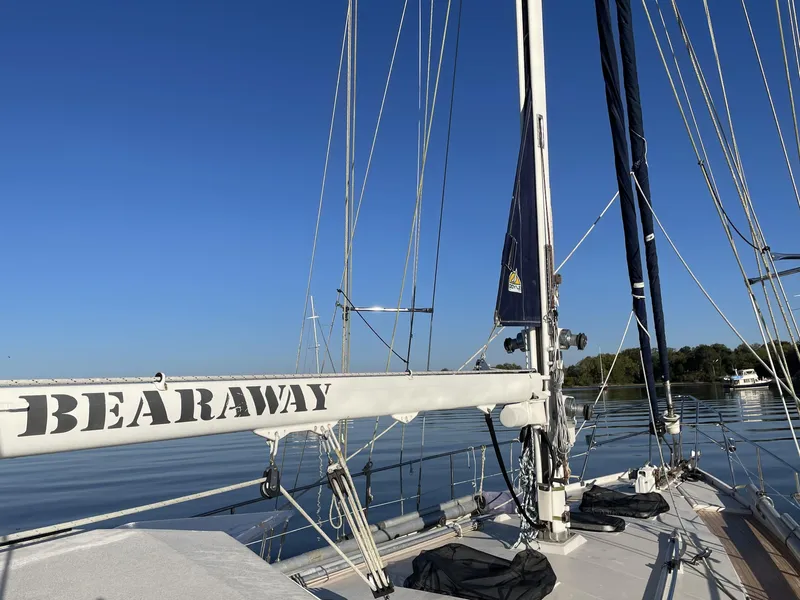 Slide: The Image of Sailboat "Bearaway" on calm water, Amel Maramu 1985 model, clear blue sky. - 43