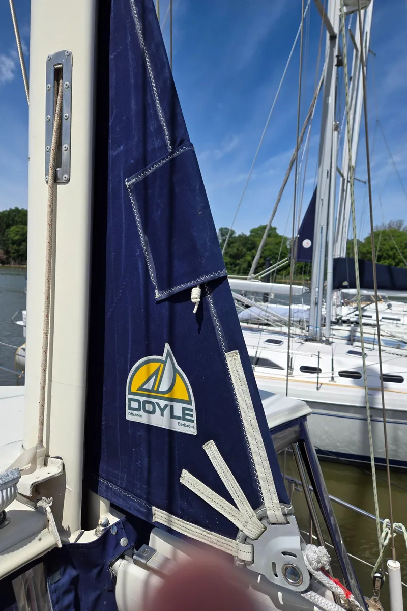 Slide: The Image of Sailboat with Doyle sail, Amel Maramu 1985, docked under clear blue sky. - 46
