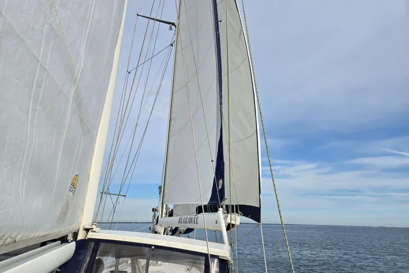 Slide: The Image of Sailing yacht Amel Maramu 1985 with full sails on open sea under clear sky. - 50