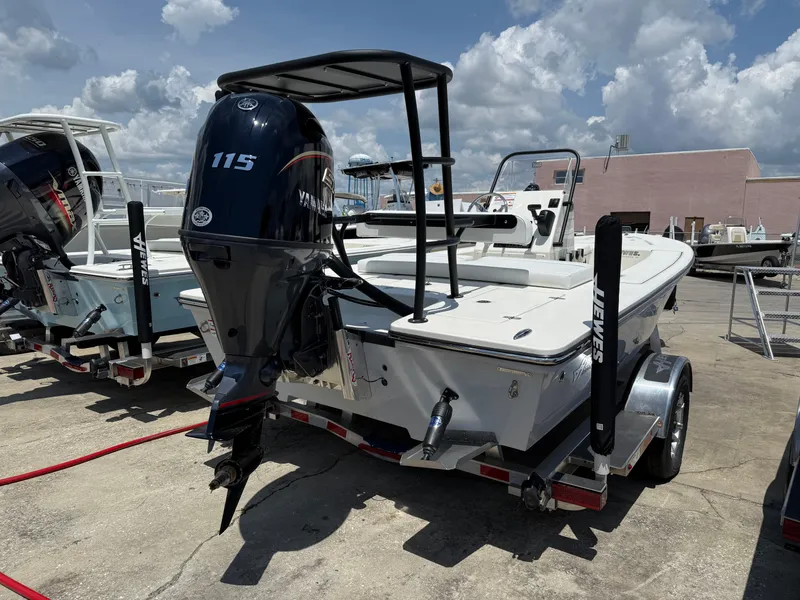 Slide: The Image of 2025 Hewes 18 Redfisher boat with Yamaha 115 engine on trailer, outdoor display. - 9