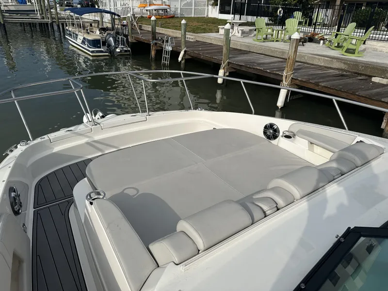 Slide: The Image of 2021 Sea Ray Sundancer 320 OB boat with spacious sun deck at marina. - 11