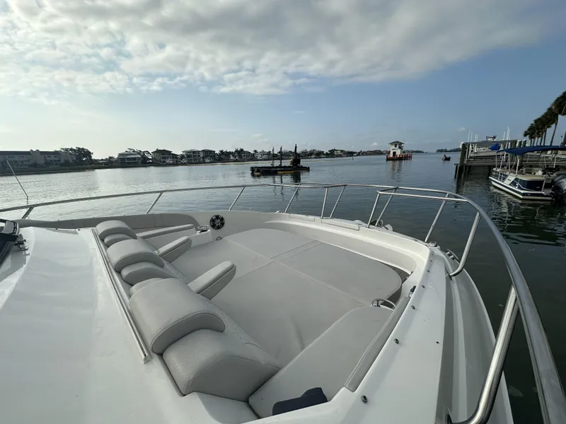 Slide: The Image of 2021 Sea Ray Sundancer 320 OB boat with spacious deck, docked in a scenic marina. - 13