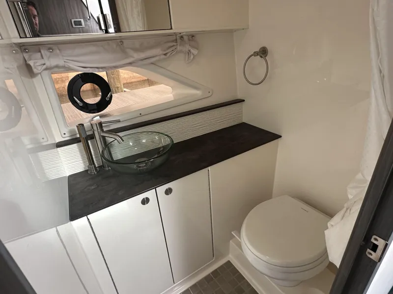 Slide: The Image of 2021 Sea Ray Sundancer 320 OB bathroom with modern sink and toilet. - 16