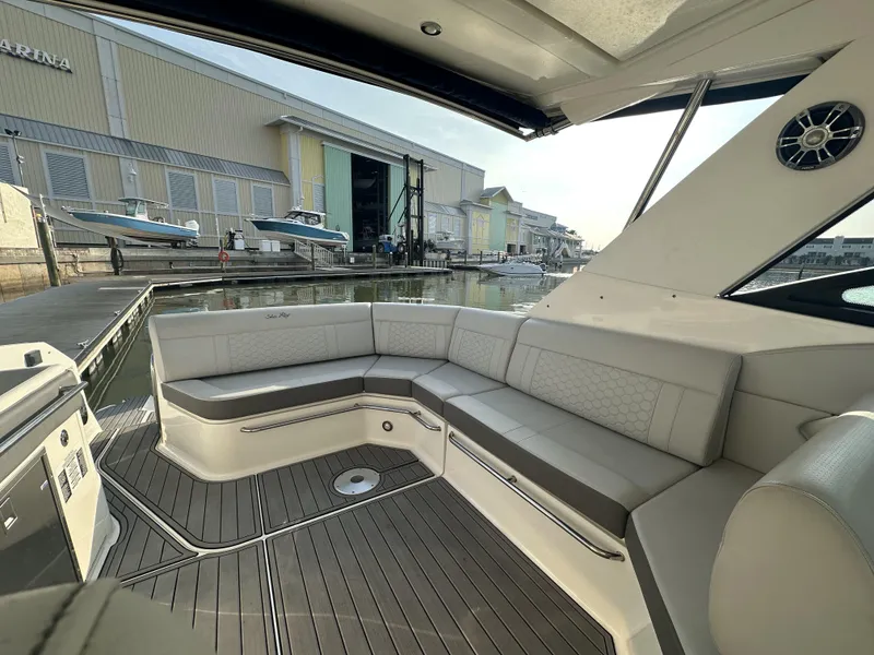 Slide: The Image of 2021 Sea Ray Sundancer 320 OB with spacious seating, docked at a marina. - 3