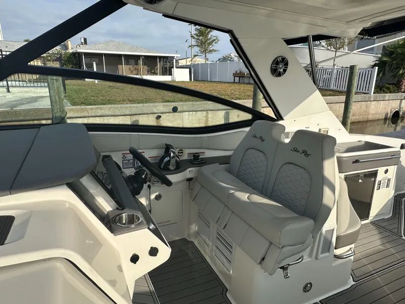Slide: The Image of 2021 Sea Ray Sundancer 320 OB cockpit with modern helm and comfortable seating. - 7