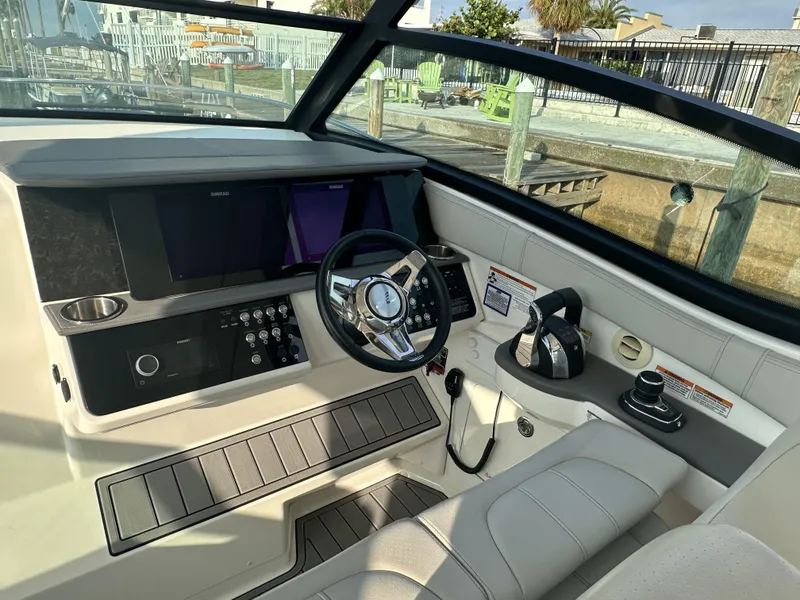 Slide: The Image of Cockpit of 2021 Sea Ray Sundancer 320 OB with modern controls and steering wheel. - 8