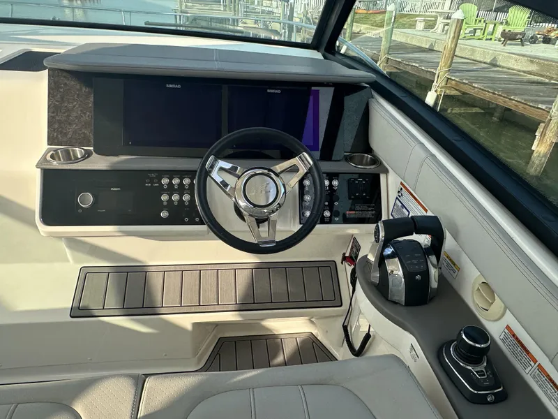 Slide: The Image of 2021 Sea Ray Sundancer 320 OB helm with modern controls and dual displays. - 9