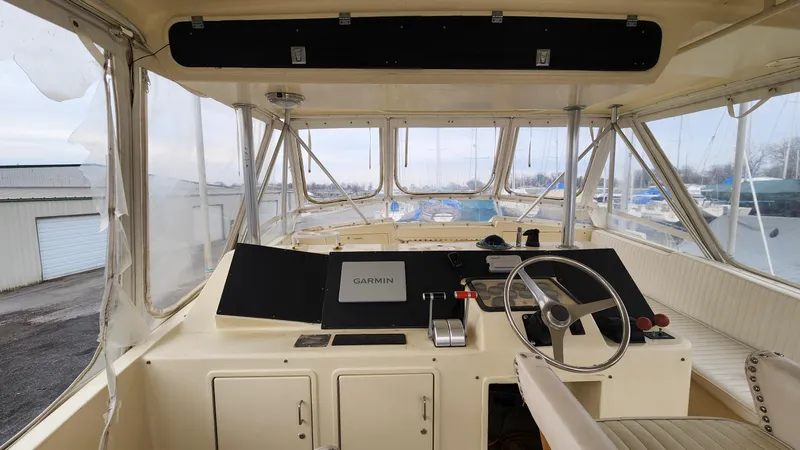 Slide: The Image of Cockpit of 1989 Ocean Yachts 55 with steering wheel and navigation equipment. - 12
