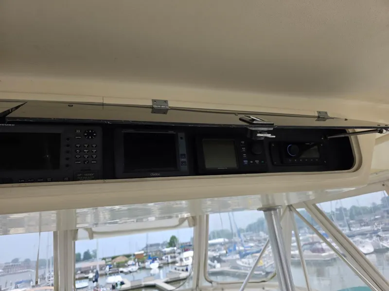 Slide: The Image of Control panel of a 1989 Ocean Yachts 55, featuring navigation and communication equipment. - 13