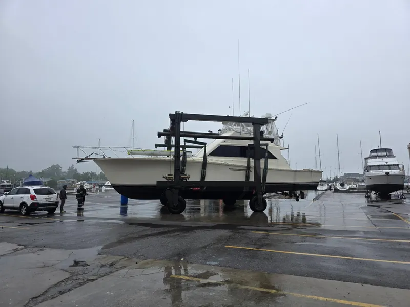 Slide: The Image of 1989 Ocean Yachts 55 on a lift at a marina on a rainy day. - 14