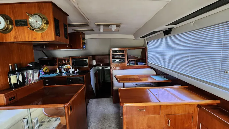 Slide: The Image of Interior of a 1989 Ocean Yachts 55, featuring a cozy kitchen and dining area. - 5