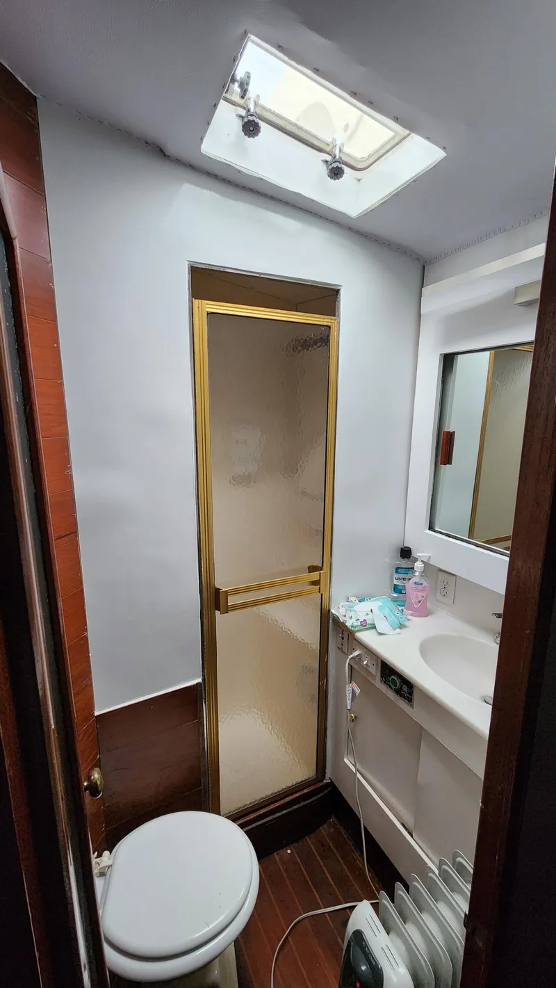 Slide: The Image of Bathroom interior of 1989 Ocean Yachts 55, featuring shower, sink, and skylight. - 9