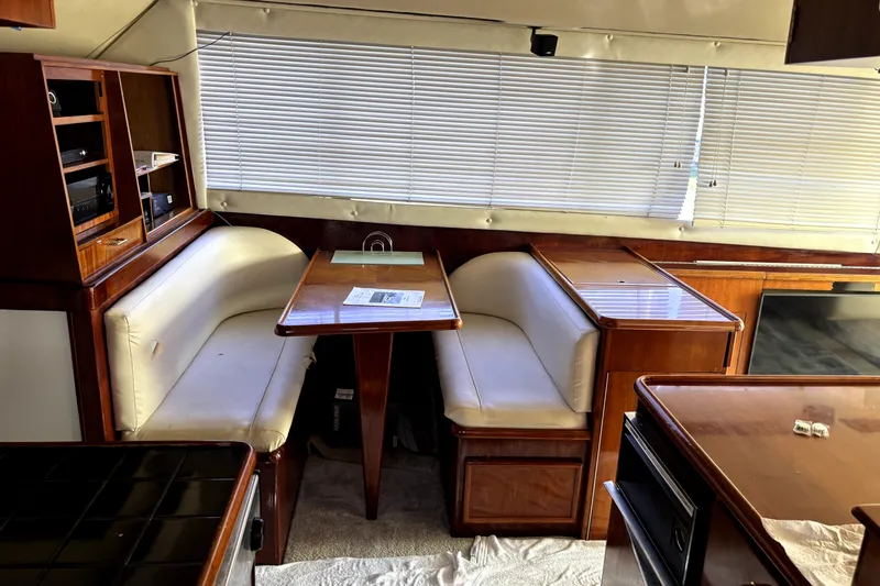 Slide: The Image of Interior of 1989 Ocean Yachts 55 Super Sport with dining area and wooden cabinetry. - 22