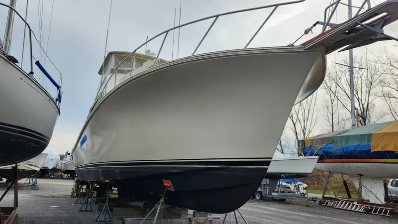 Slide: The Image of 1989 Ocean Yachts 55 boat on dry dock, side view, with other boats nearby. - 2