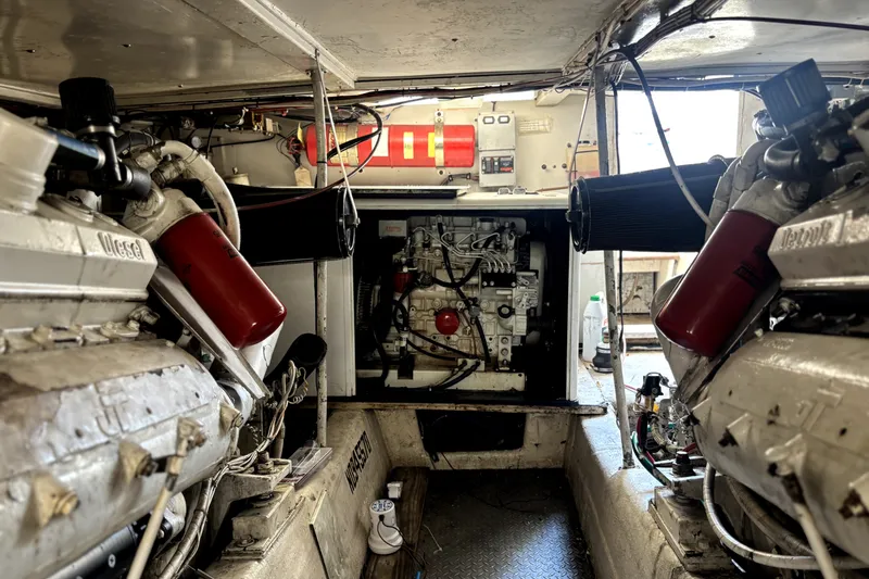 Slide: The Image of Engine room of a 1989 Ocean Yachts 55 Super Sport, showcasing dual diesel engines. - 27