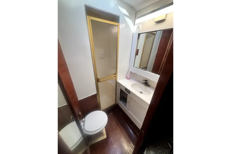 Slide: The Image of Bathroom interior of 1989 Ocean Yachts 55 Super Sport with shower, sink, and toilet. - 32