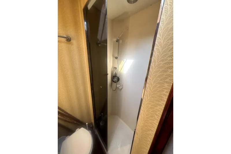 Slide: The Image of Shower area in 1989 Ocean Yachts 55 Super Sport, featuring elegant wallpaper and modern fixtures. - 36