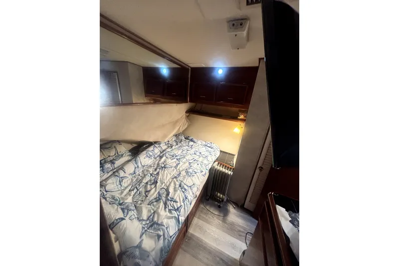 Slide: The Image of Cozy cabin interior of 1989 Ocean Yachts 55 Super Sport with nautical-themed bedding. - 31