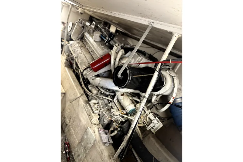Slide: The Image of Engine compartment of a 1989 Ocean Yachts 55 Super Sport, showcasing mechanical components. - 26