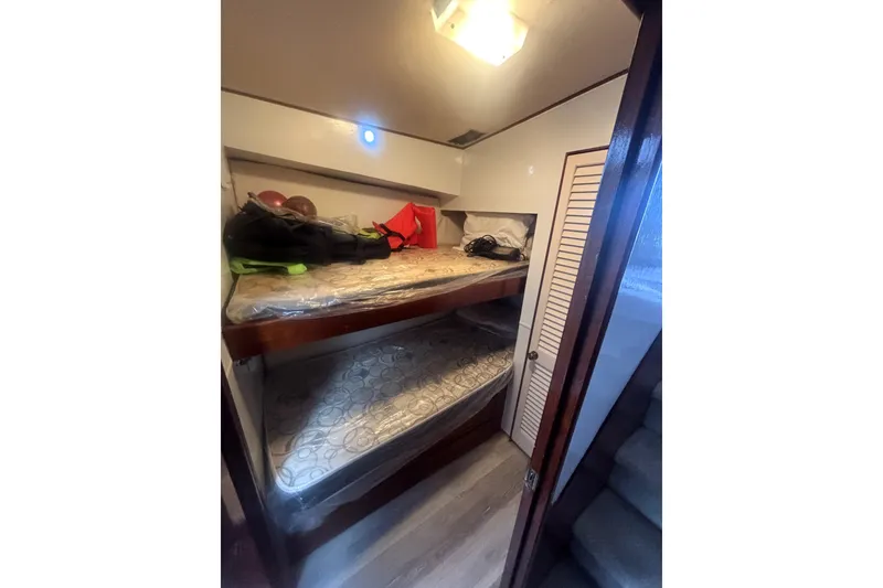 Slide: The Image of Interior cabin of 1989 Ocean Yachts 55 Super Sport with bunk beds and storage. - 29