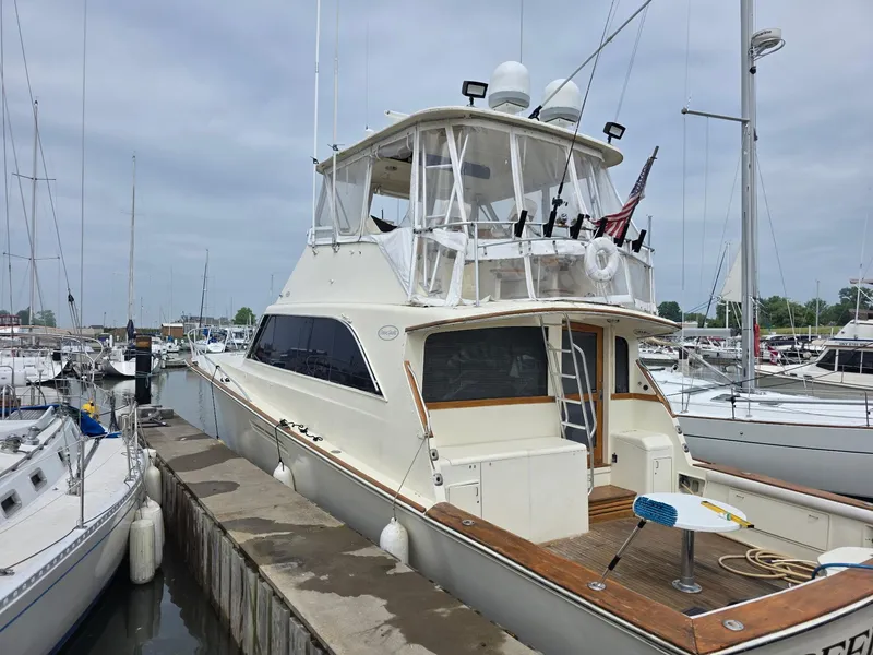 The Image of 1989 Ocean Yachts 55 docked in a marina, surrounded by other boats. - 0