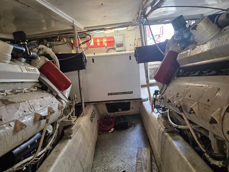 Slide: The Image of Engine room of a 1989 Ocean Yachts 55, featuring dual diesel engines and equipment. - 19