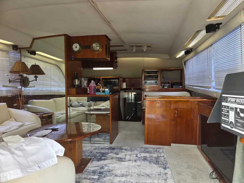 Slide: The Image of Interior of a 1989 Ocean Yachts 55, featuring wood cabinetry and comfortable seating. - 8