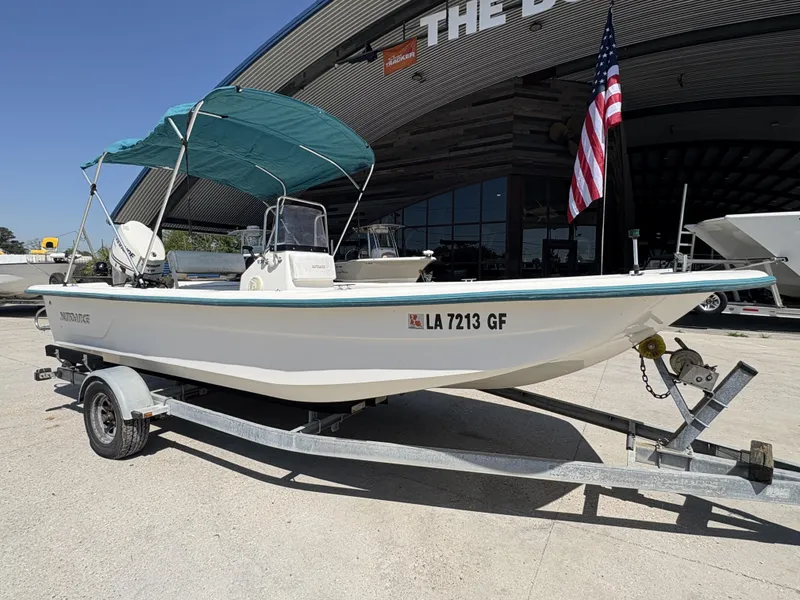 Slide: The Image of Bow seating area of a 2007 Sundance B20 boat, featuring cushioned benches and storage compartments. - 3