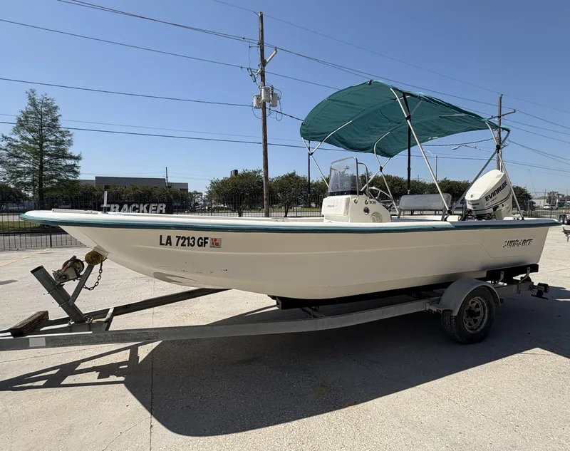 Slide: The Image of 2007 Sundance B20 boat with Evinrude engine on trailer, featuring a green canopy. - 6