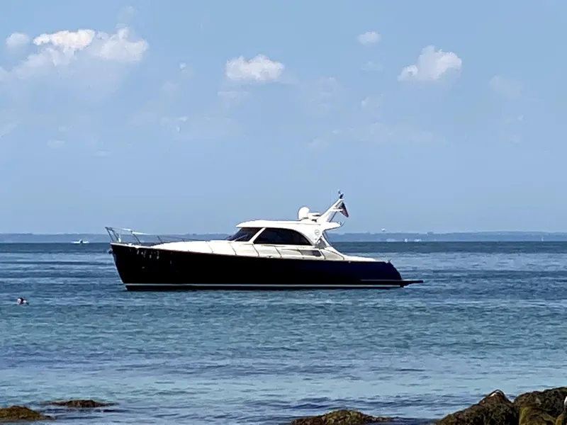 Slide: The Image of 2007 Mochi Craft 44 Dolphin yacht on calm sea under blue sky. - 1
