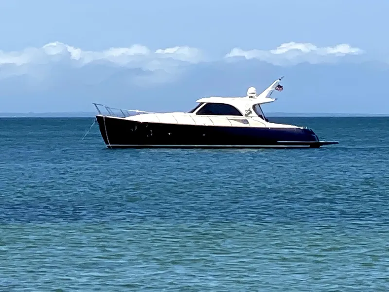 Slide: The Image of 2007 Mochi Craft 44 Dolphin yacht on calm blue sea under clear sky. - 2