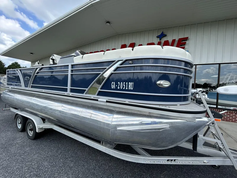 Slide: The Image of 2020 Veranda VP22VLC pontoon boat on trailer outside a building. - 1