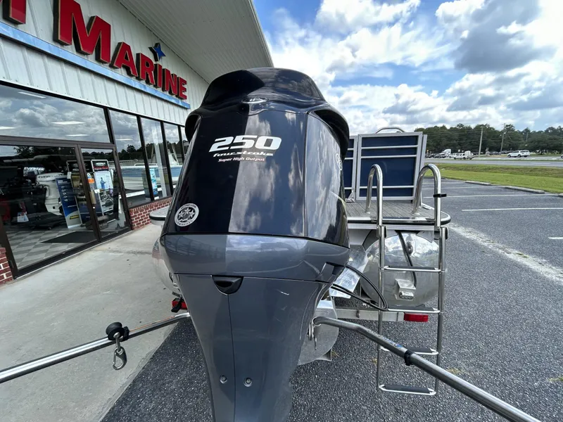 Slide: The Image of 2020 Veranda VP22VLC with 250 HP outboard motor outside a marine store. - 2