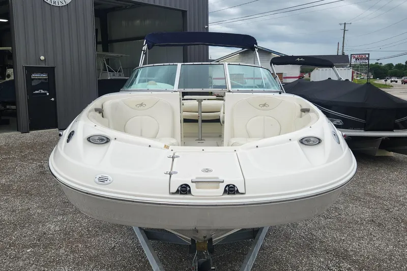 Slide: The Image of 2003 Monterey 253 Explorer Sport boat with open bow seating, parked outdoors. - 2
