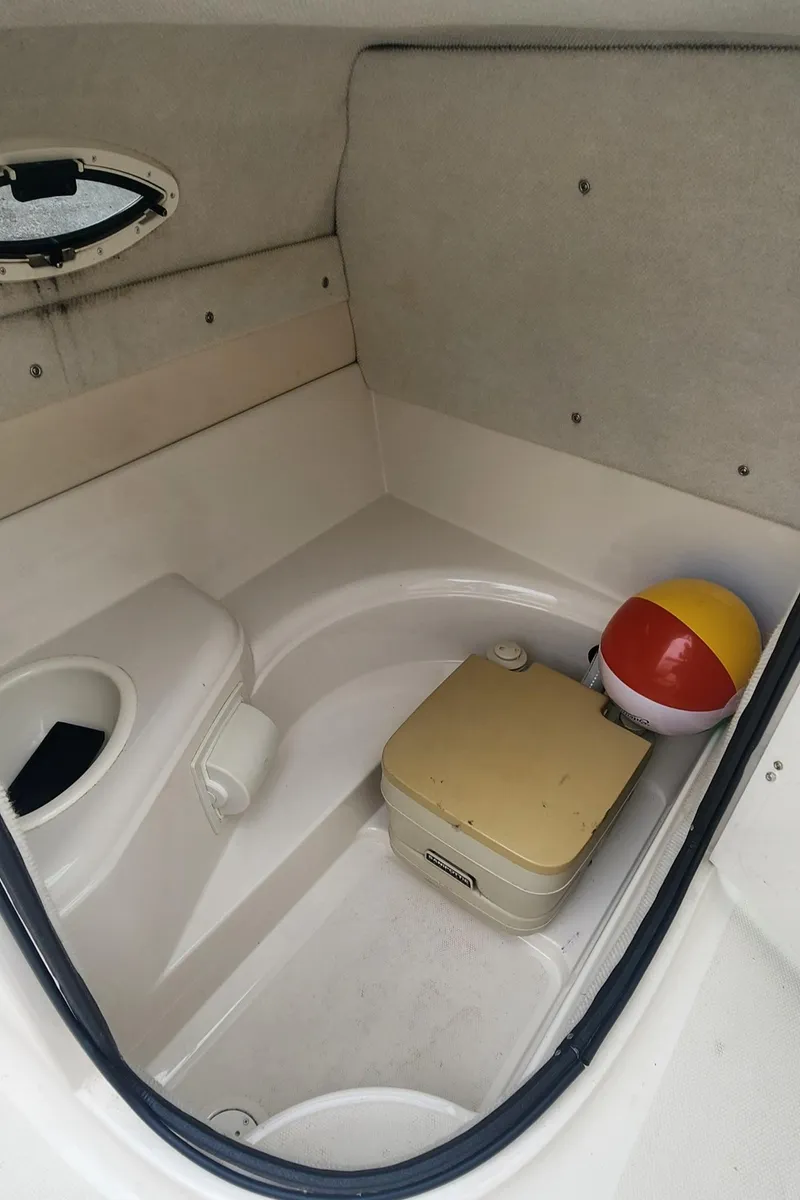 Slide: The Image of 2003 Monterey 253 Explorer Sport cabin interior with portable toilet and beach ball. - 9