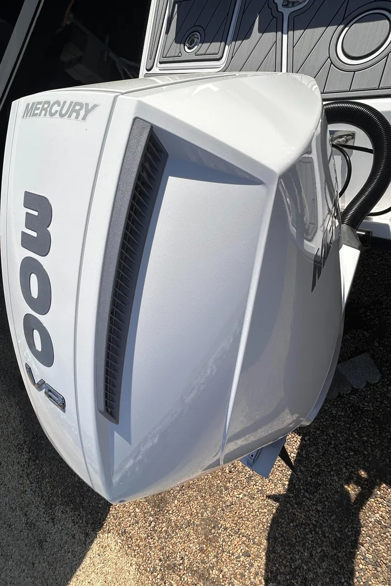Slide: The Image of 2025 Monterey M65 boat with Mercury 300 V8 outboard engine, white exterior. - 10