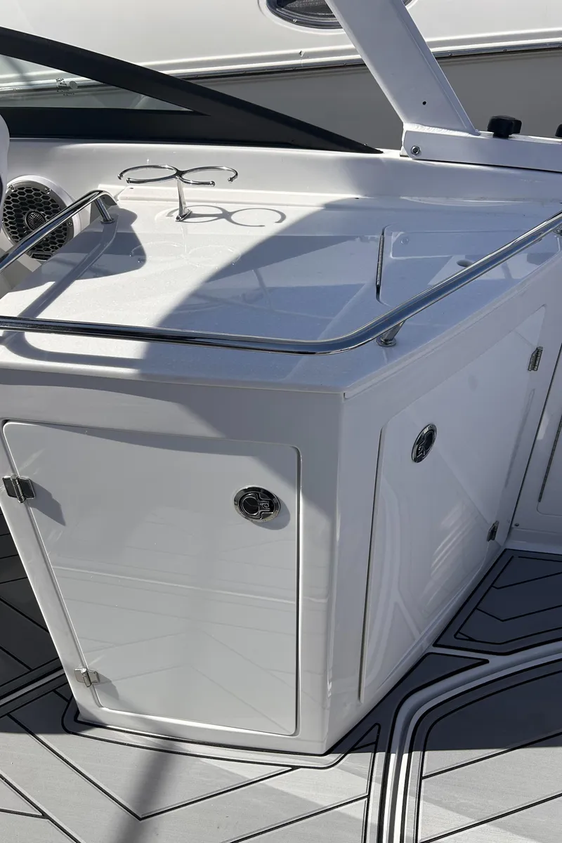 Slide: The Image of 2025 Monterey M65 boat interior with sleek white cabinetry and modern design. - 11