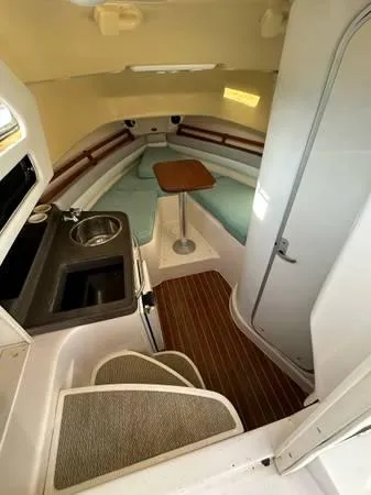 Slide: The Image of 2005 Grady-White Marlin 300 cabin interior with kitchenette and seating area. - 7