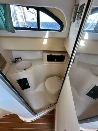 Slide: The Image of 2005 Grady-White Marlin 300 boat bathroom interior with sink and toilet. - 9