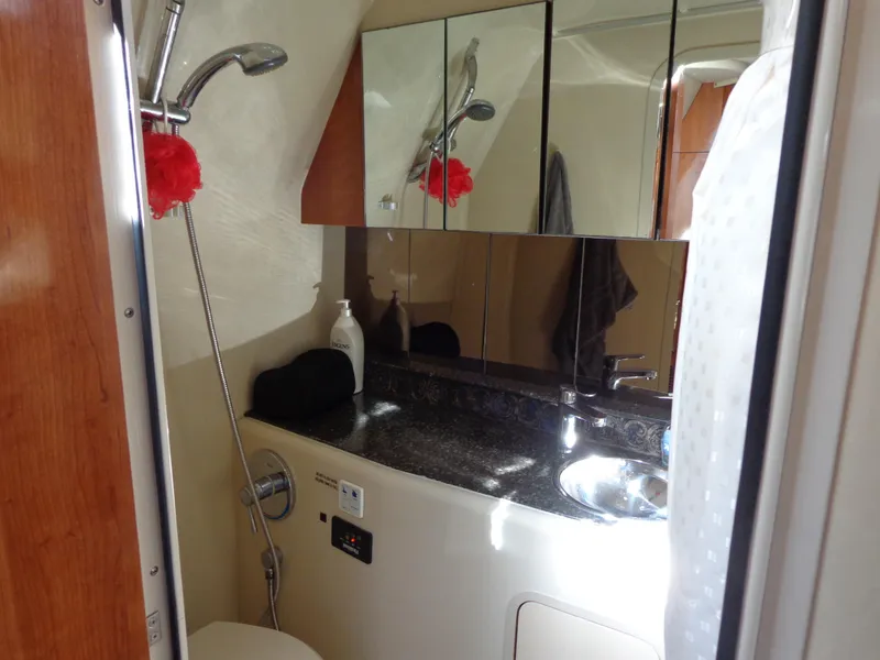 Slide: The Image of 2008 Cruisers Yachts 330 Express bathroom with shower, sink, and mirrored cabinets. - 15