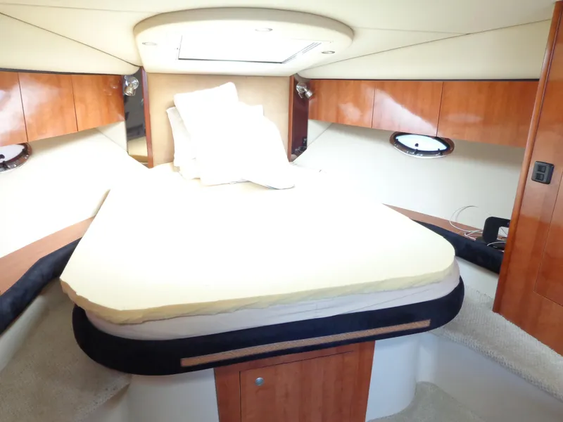 Slide: The Image of Luxurious cabin interior of 2008 Cruisers Yachts 330 Express with cozy bed and wooden accents. - 16