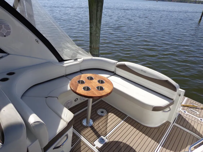 Slide: The Image of 2008 Cruisers Yachts 330 Express interior with seating and table, overlooking water. - 3
