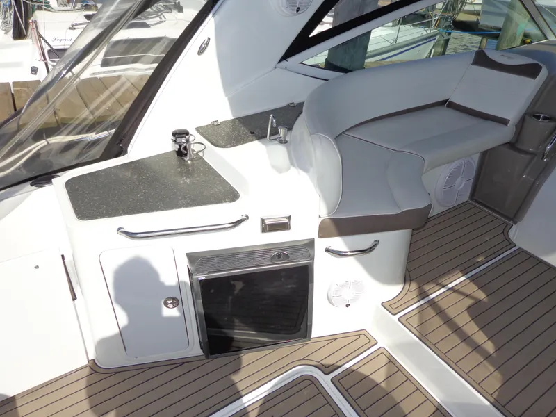 Slide: The Image of 2008 Cruisers Yachts 330 Express interior with seating and kitchenette area. - 4