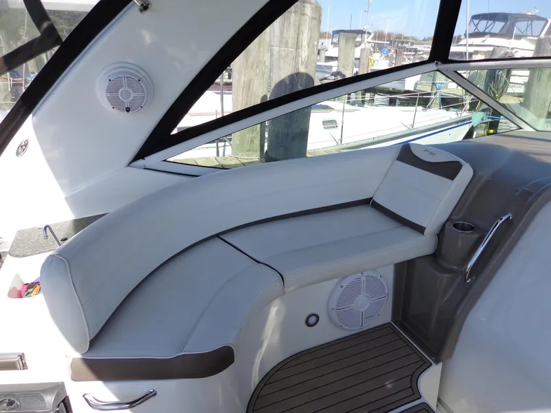 Slide: The Image of 2008 Cruisers Yachts 330 Express interior seating with speakers and wood flooring. - 5