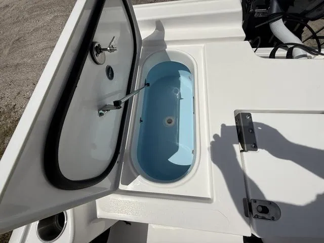 Slide: The Image of 2024 Tidewater 2410 Bay Max boat livewell with open lid, showcasing interior design. - 26