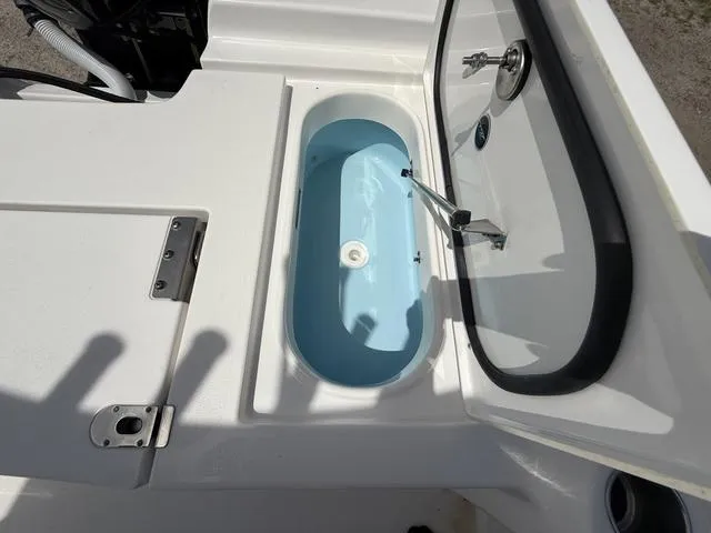 Slide: The Image of 2024 Tidewater 2410 Bay Max boat livewell with open lid and water inside. - 27