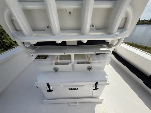 Slide: The Image of 2024 Tidewater 2410 Bay Max boat with storage compartments and Yeti cooler. - 31