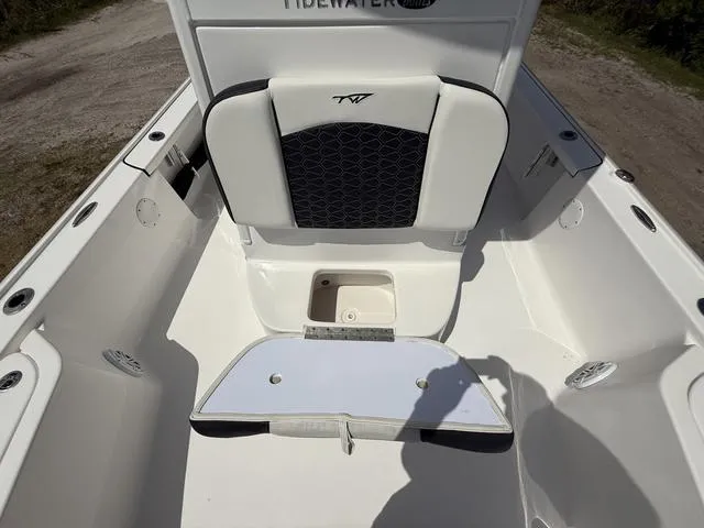 Slide: The Image of 2024 Tidewater 2410 Bay Max boat interior with seating and storage compartment. - 37